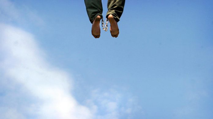 The body of Iranian serial killer hangs in the town of Pakdasht south of Tehran.