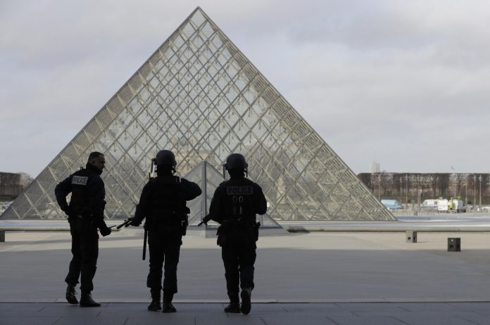 French police secure the site near the Louvre Pyramid in Paris