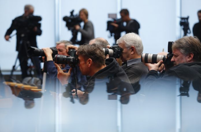 Journalists take pictures during a news conference of German Economy Minister Gabriel in Berlin