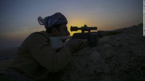 Kurdish Peshmerga fighters prepare to fire a rocket launcher Thursday near Bashiqa, outside Mosul.